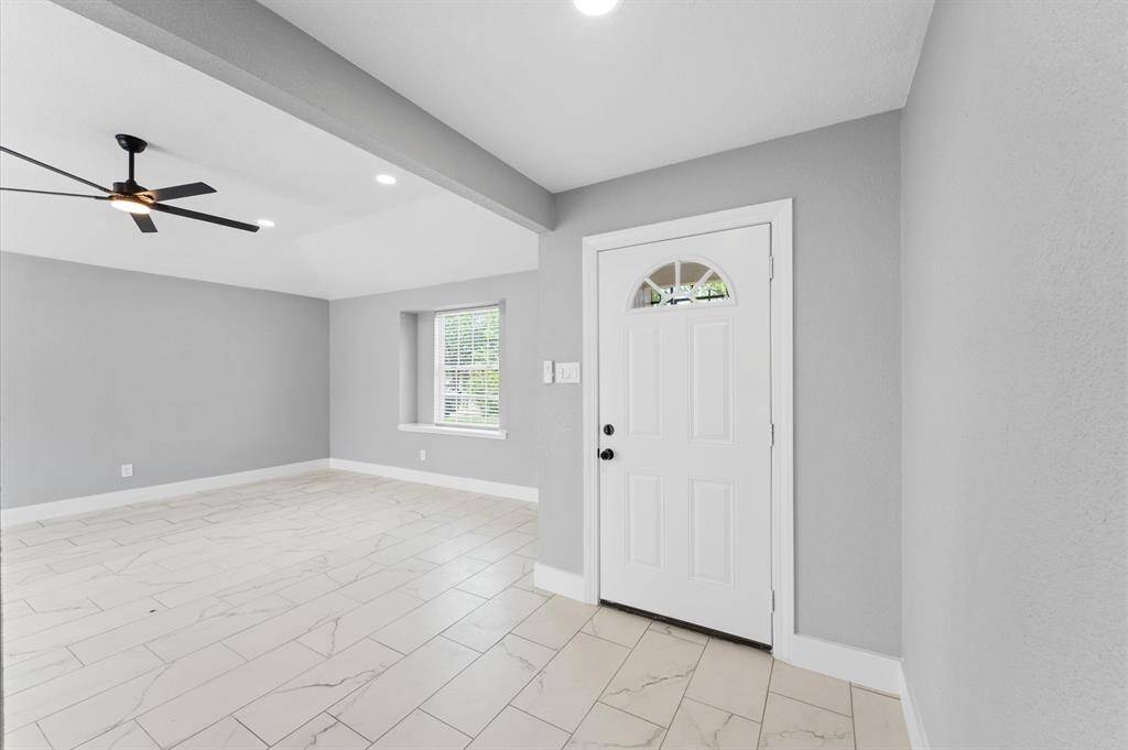 Another view of the light and airy entryway and living room.