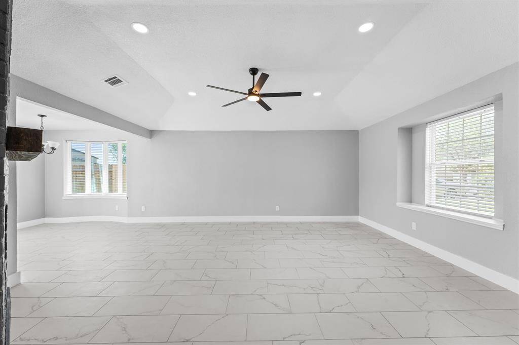 Contemporary ceiling fan in the warm and open living room
