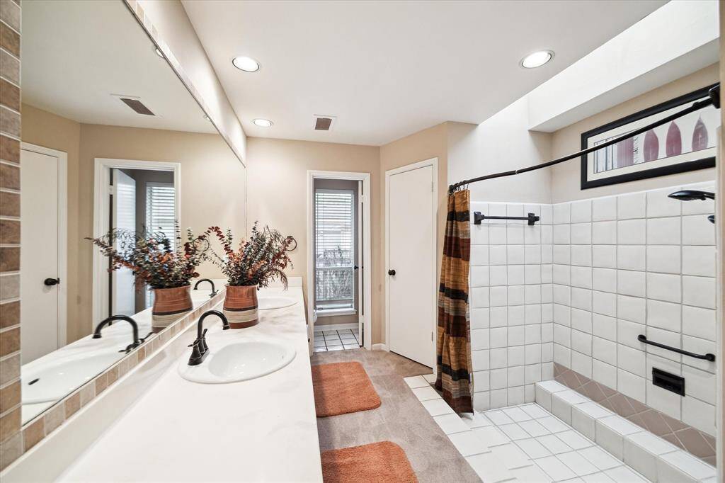 Primary bathroom with double sinks and a huge shower.