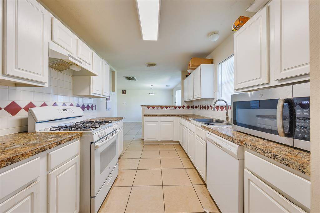 Another view from the kitchen opens up to the bright, spacious living and dining combo, ideal for entertaining and family gatherings.