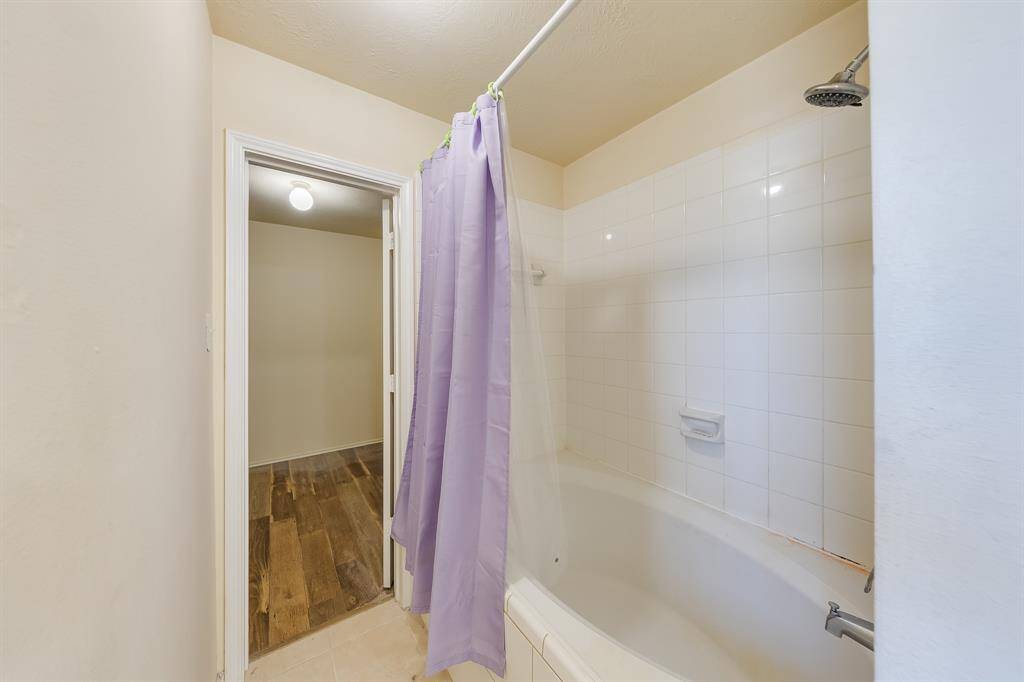 Relax in a spacious bathtub, larger than standard, with direct access to a roomy closet, perfect for all your accessories and storage needs.