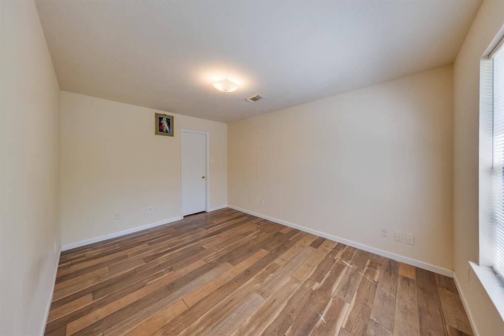 Another view of the spacious second bedroom, bathed in natural light, perfect for bringing your design vision to life.