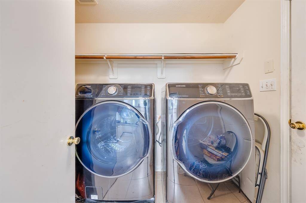 The laundry room is located next to the kitchen, with direct access to the garage, perfect for easy multitasking and convenience.