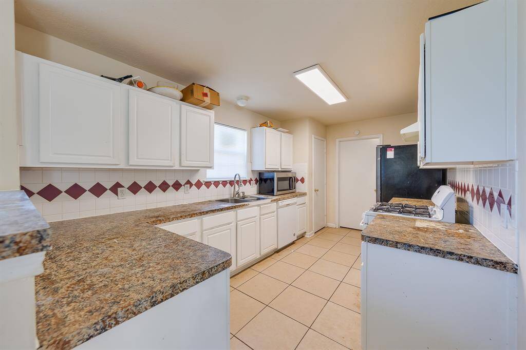 Spacious kitchen filled with natural light, perfect for cooking while multitasking, easy access to laundry, making your daily routine seamless.