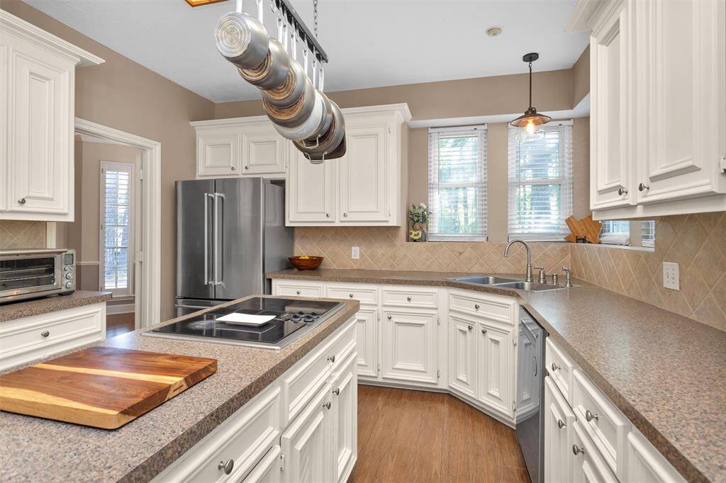 Tiled, island kitchen with cute pot hangar