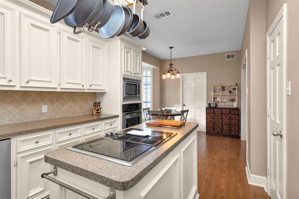 Electric, down-draft Jenn-Air cooktop on the island