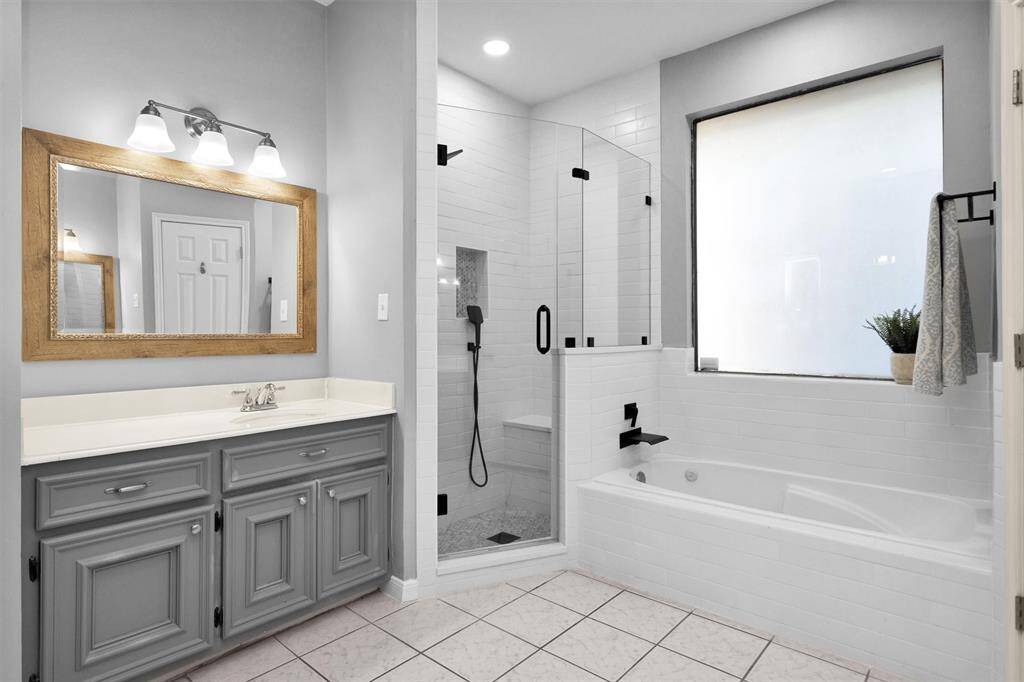 Corner, frameless glass shower with soaking tub