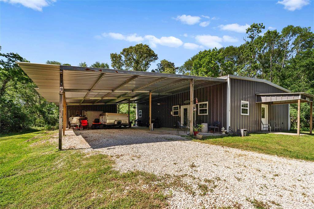 The inviting front porch and covered extended carport and seating area create the ideal spot for enjoying morning coffee or relaxing in the shade. The main entrance leads to a well-maintained interior, while the covered space doubles as an outdoor entertainment, work or parking area. No worries about getting wet on a rainy day when going out to the car.