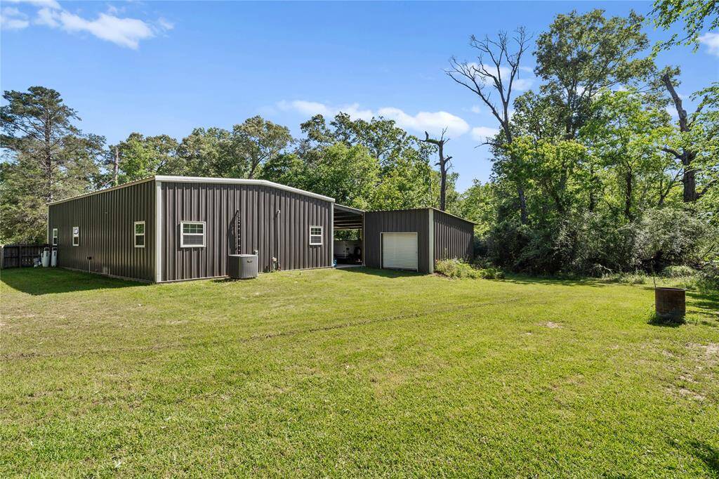 View of backyard and shed.  Notice the water softener to the left of the home.