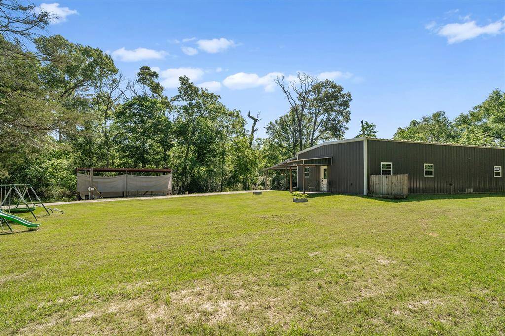 View of the side yard. Imagine all of the fun games to be played in this spacious yard. Plant a garden, add a pool, it's all up to you!