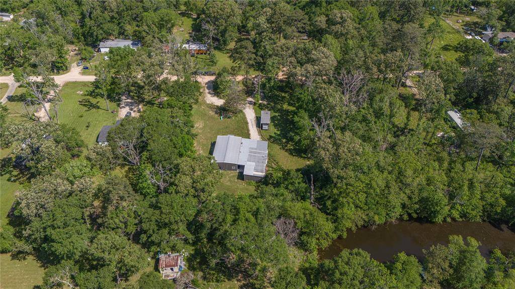 Birds eye view of the backyard. Home with carport and shed.
