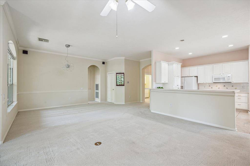 Another view of the kitchen, open to the expansive family room, creating a seamless connection between the two spaces. Beyond the family room, the spacious dining room offers ample room for gatherings, enhancing the functionality of the entire living area.