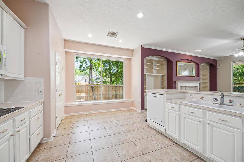 The kitchen offers abundant cabinet space, ensuring plenty of storage for all of your culinary essentials. A cozy breakfast area adds a charming touch, creating a perfect spot to enjoy your morning coffee.