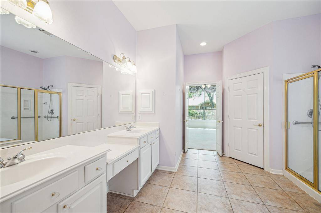 The primary bathroom is accessed through double doors, offering plenty of room and a simple, functional layout.