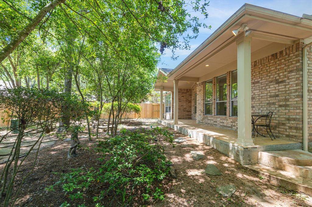 The backyard of this home is beautifully surrounded by mature trees, creating a peaceful and private backyard retreat. The natural landscape enhances the tranquility of the space.