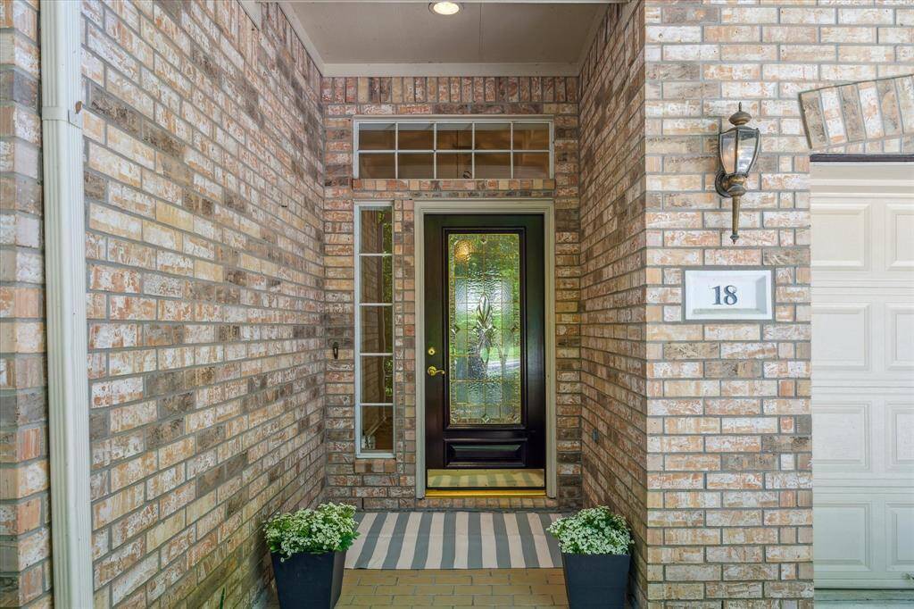 The charming covered front porch highlights the leaded glass front door, sidelight, and transom.