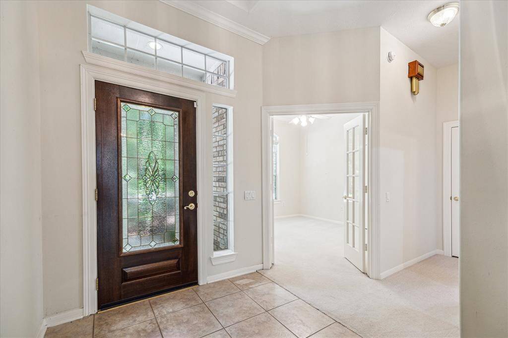 Upon entering, to the left you will find a spacious office with a walk-in closet, which is perfect for working from home or an additional bedroom. Just beyond, a secondary bedroom with its own dedicated full bath is thoughtfully tucked away in a private wing, offering a quiet and secluded retreat separate from the main living areas.