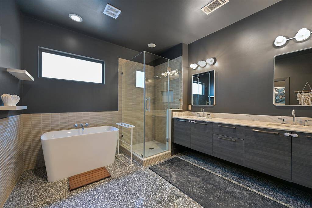 Exquisite primary ensuite recently remodeled with a contemporary flare, including a Japanese soaking tub and a Travertine tile floor.