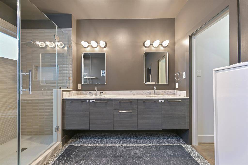 View of the double vanity in the primary ensuite and sizeable walk in shower.
