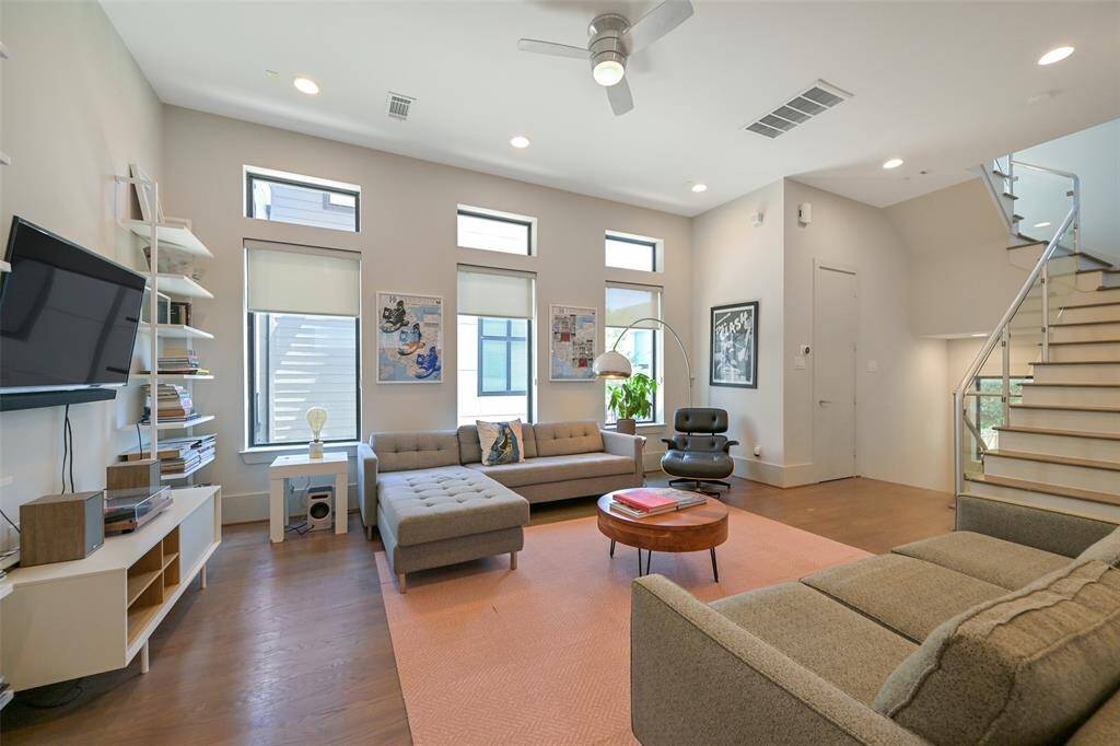 View of living room leading to the stairway to the office nook, utility room and primary and secondary bedrooms.