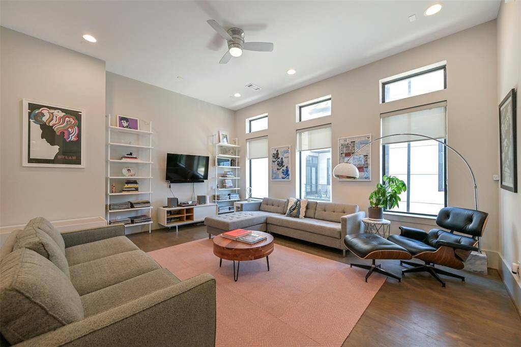 Living room offers plenty of natural light and high ceilings.