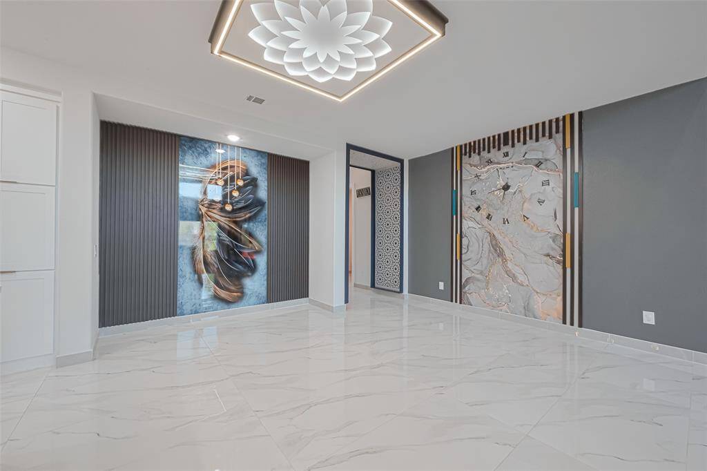The formal dining room is a true showstopper with accent ceiling designs, stylish wall paneling, and an ambiance perfect for hosting.