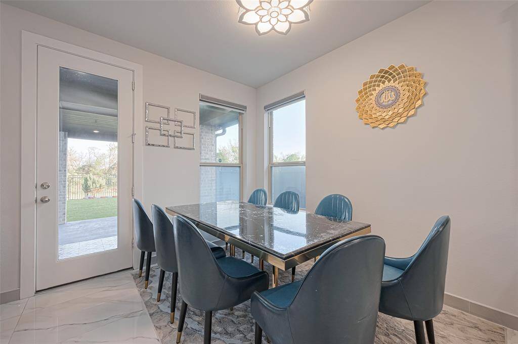 A bright breakfast area invites casual dining while overlooking the lush backyard.