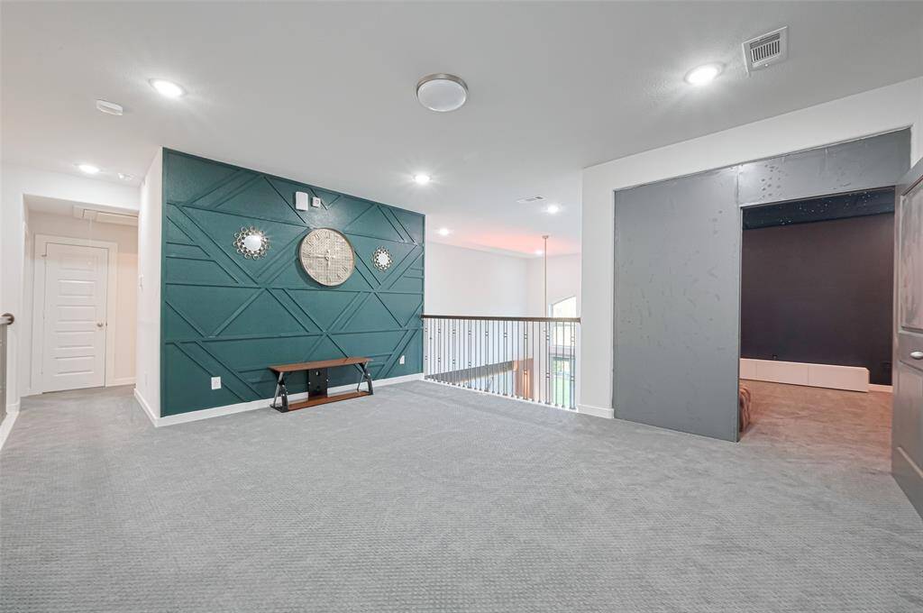Upstairs, discover a large game room with a sitting area, balcony views of the foyer, and an adjacent media room, perfect for movie nights.