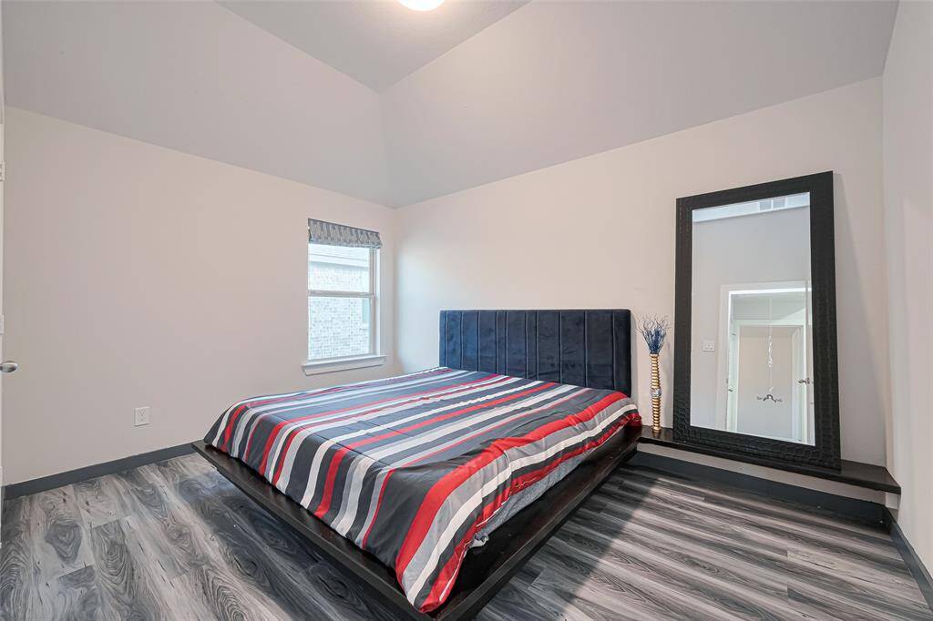 Two secondary bedrooms—this one with wood-look vinyl floors!