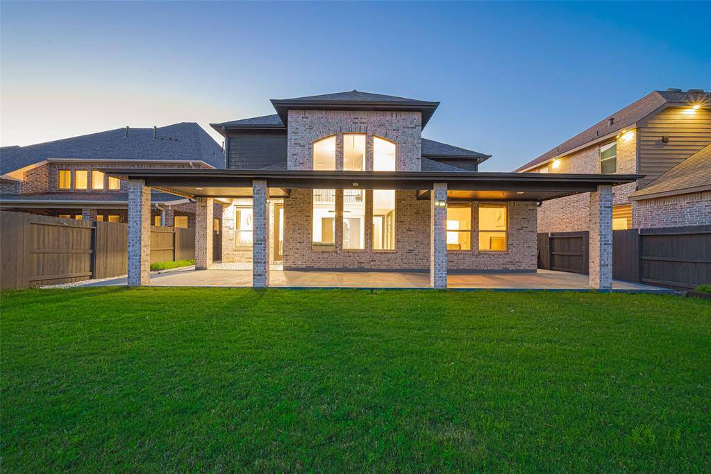 Step outside to your covered and extended tile-paved patio, ideal for entertaining or relaxing in the expansive backyard with direct gate access to the tranquil lake. A sprinkler system, full gutters, and lush landscaping enhance the home’s curb appeal and functionality.