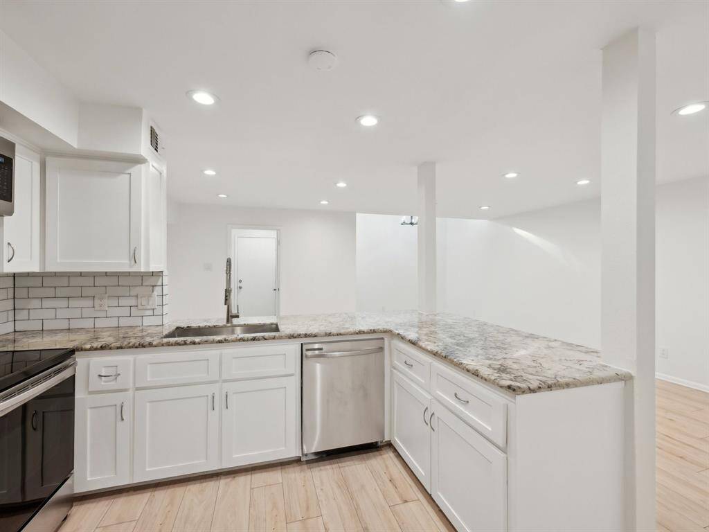 This townhome has beautiful countertops and a trendy, subway tile backsplash.