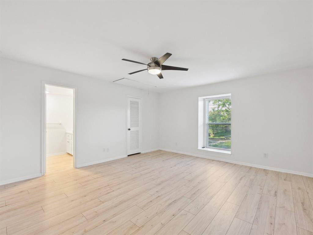 The upstairs Primary Bedroom is spacious and has a walk-in closet.