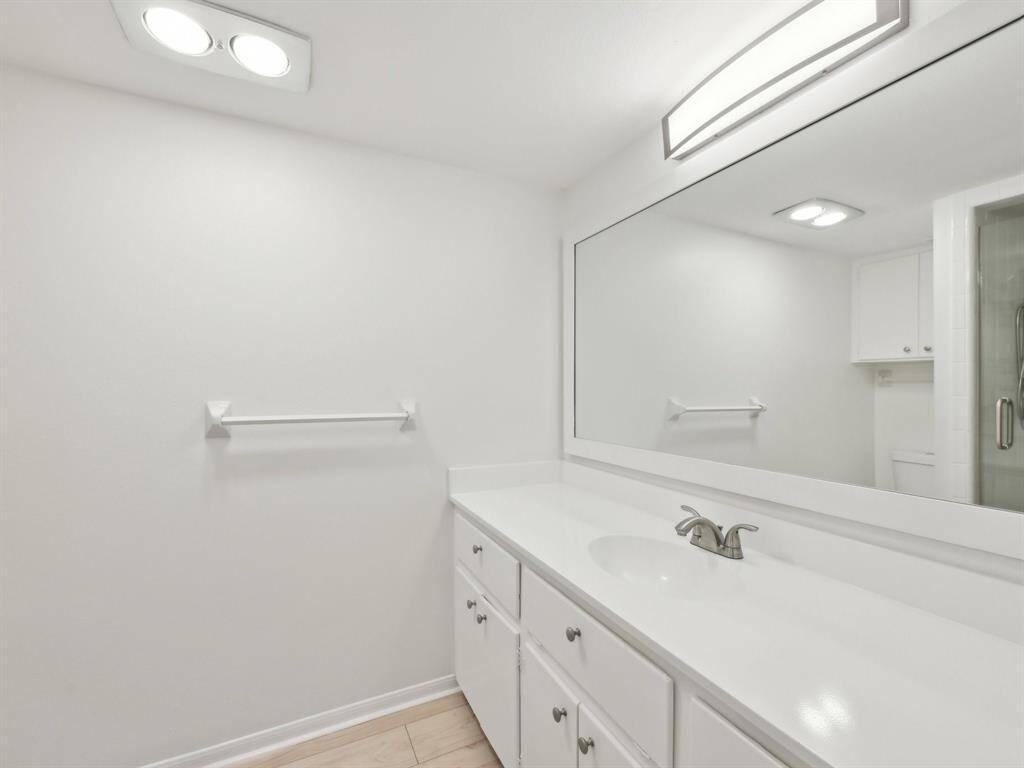The Primary ensuite has a freshly resurfaced counter, framed mirror and snazzy shower.