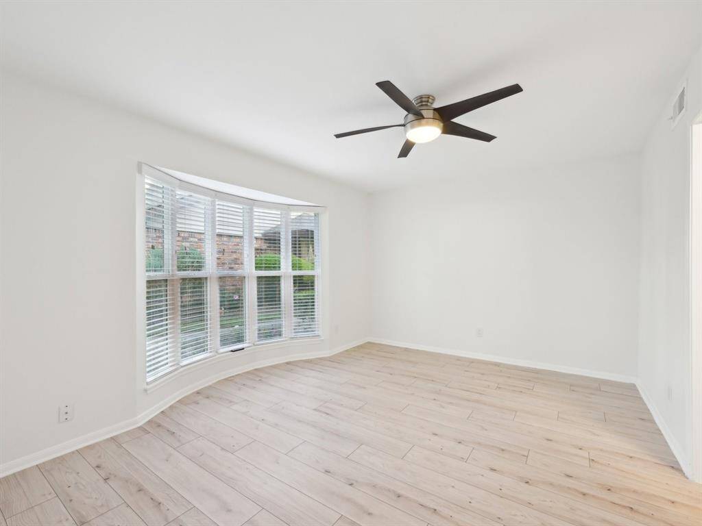The downstairs Primary Bedroom has a beautiful bay window.