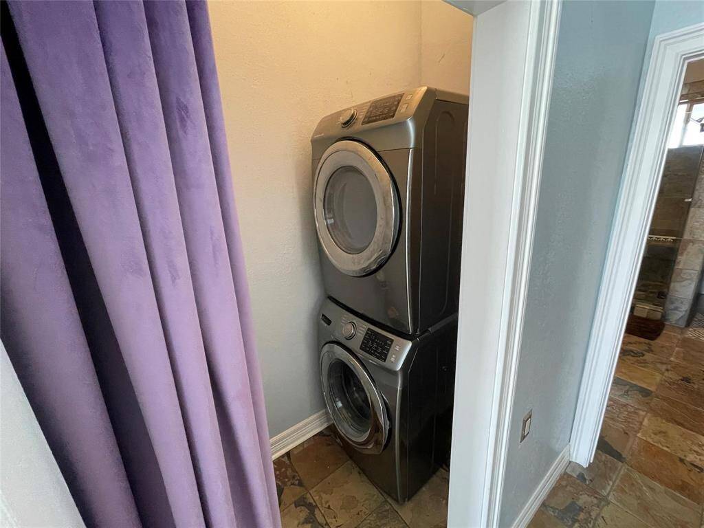 This unit includes a laundry area with a stacked washer and dryer.