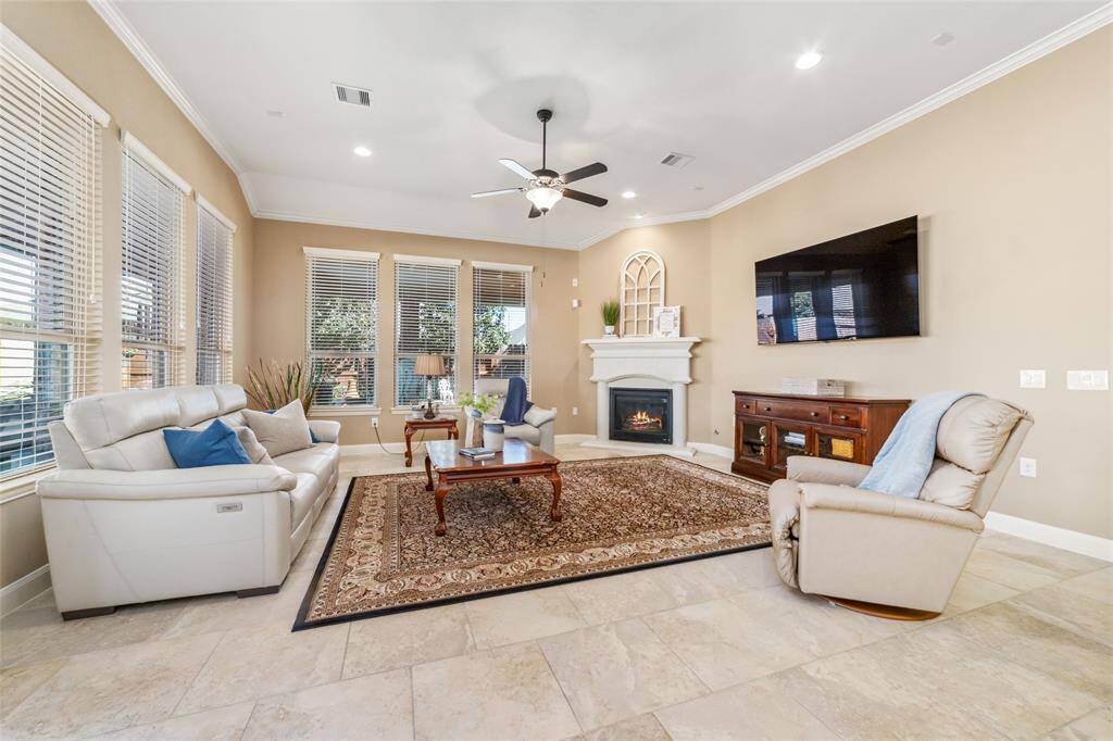 Large living room with high ceilings, wall to wall windows, and gas log fireplace!