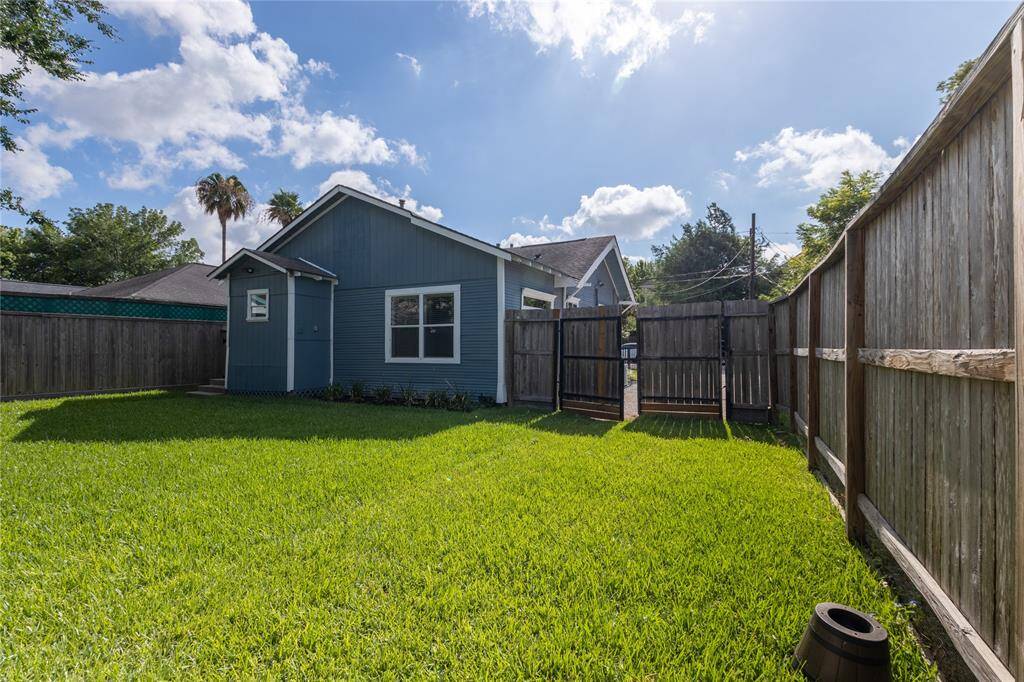 Another view of backyard showing gate to private driveway.