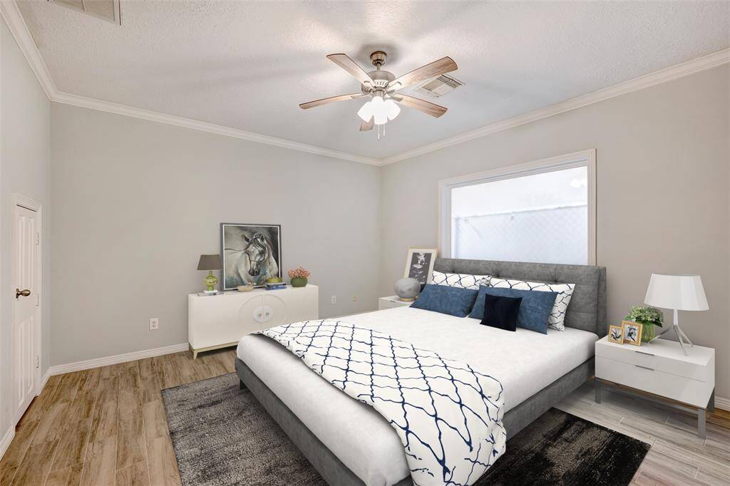 The first-floor bedroom with full bath offers an ideal space for a home office, fitness room or guest suite. Virtually staged photo.