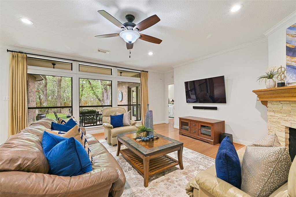The centerpiece of the living space in this home is a wall-to-wall window that frames the peaceful, park-like view of the backyard paradise that includes a wooded perimeter surrounding a lush & manicured centerpiece with a fantastic patio and in-ground spool (spa/pool).