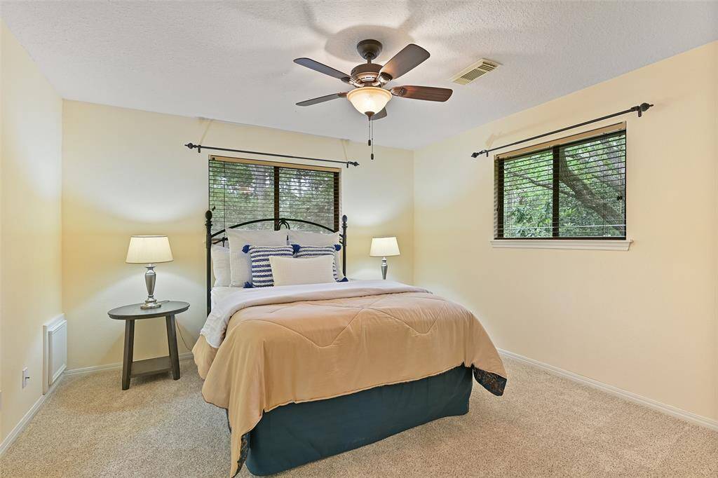 On one side of the gameroom, there are two secondary bedrooms that share a Jack & Jill style bathroom. This bedroom offers a soft & buttery paint selection, plush carpet, two windows with 2" blinds, and a roomy walk-in closet.