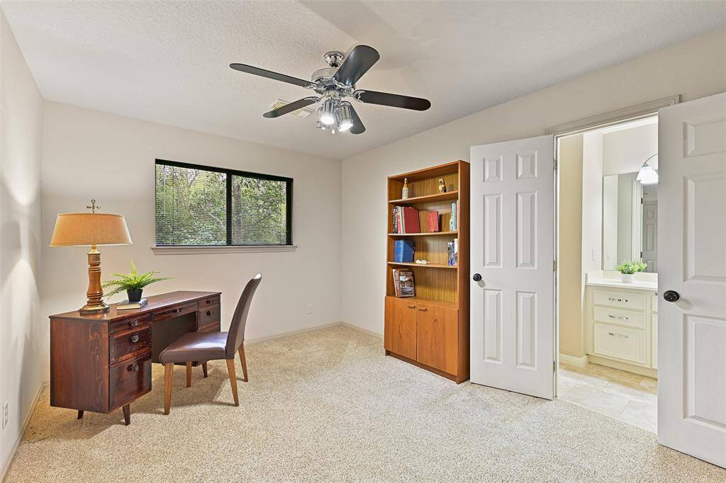 This bedroom is adjacent to the gameroom and it offers fresh neutral paint, a lighted ceiling fan, a side-facing window with blinds, a huge 11'x6' walk-in closet with shelving, and a Jack & Jill style bathroom that is also accessible from the game room.