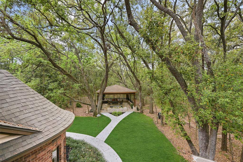Step out the French doors in the gameroom onto the breezy balcony to enjoy the fabulous view of the backyard which includes a wooded perimeter and a manicured center anchored by a fabulous gazebo with an in-ground spool (spa/pool).