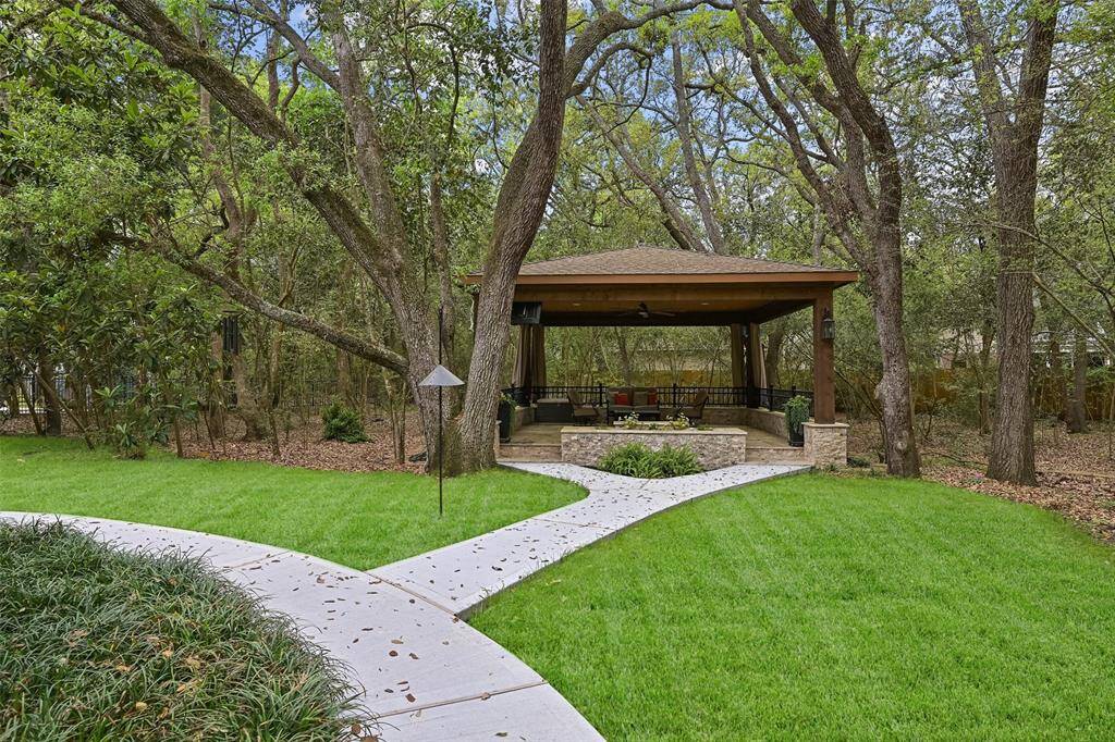 Enjoy the backyard retreat, complete with an in-ground sprinkler system, landscape lighting, a mosquito misting system, a recent privacy fence, and a newly poured concrete pathway leading to the covered patio with travertine tile floors, recessed lighting, a fan, TV capabilities, and a relaxing spool.