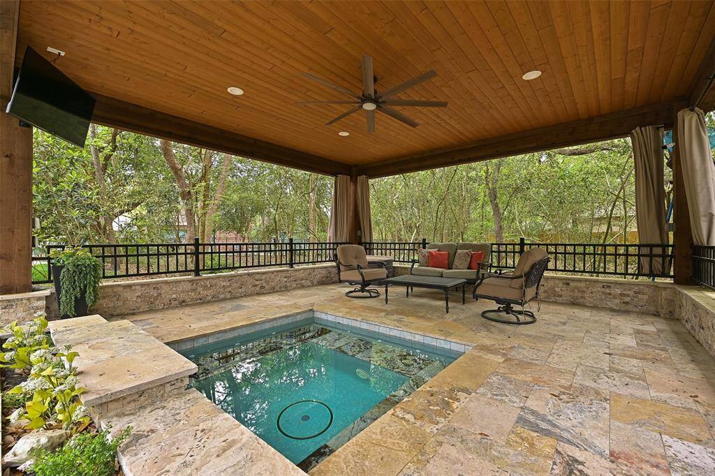 Enjoy the backyard retreat, complete with an in-ground sprinkler system, landscape lighting, a mosquito misting system, a recent privacy fence, and a newly poured concrete pathway leading to the covered patio with travertine tile floors, recessed lighting, a fan, TV capabilities, and a relaxing spool.