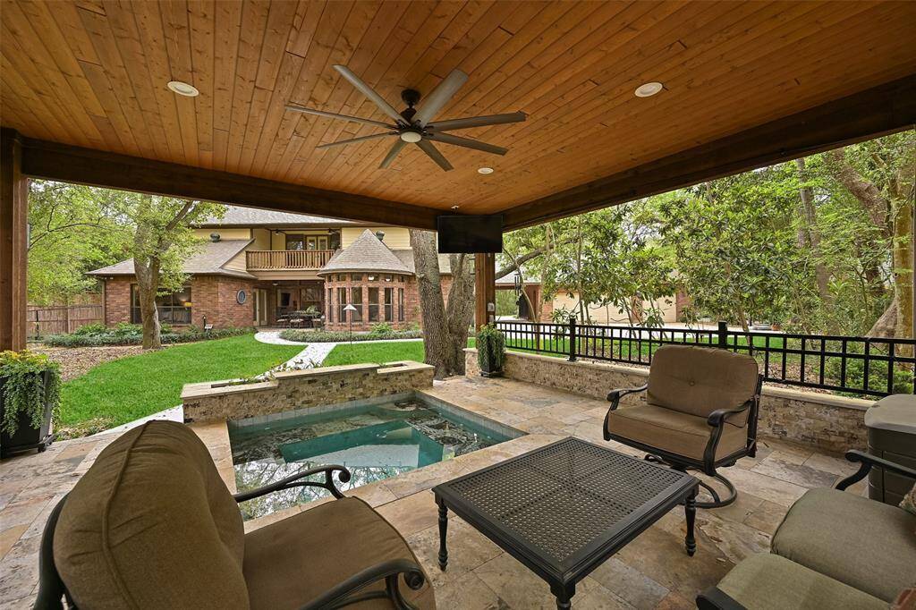 Enjoy the backyard retreat, complete with an in-ground sprinkler system, landscape lighting, a mosquito misting system, a recent privacy fence, and a newly poured concrete pathway leading to the covered patio with travertine tile floors, recessed lighting, a fan, TV capabilities, and a relaxing spool.