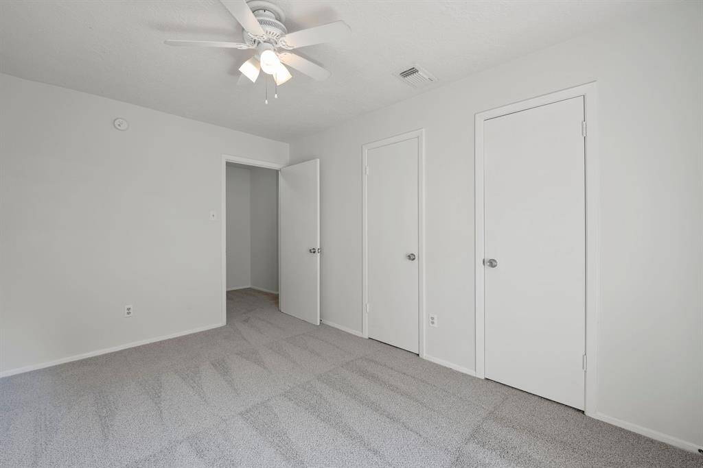 Secondary bedroom has sitting area in the hallway.
