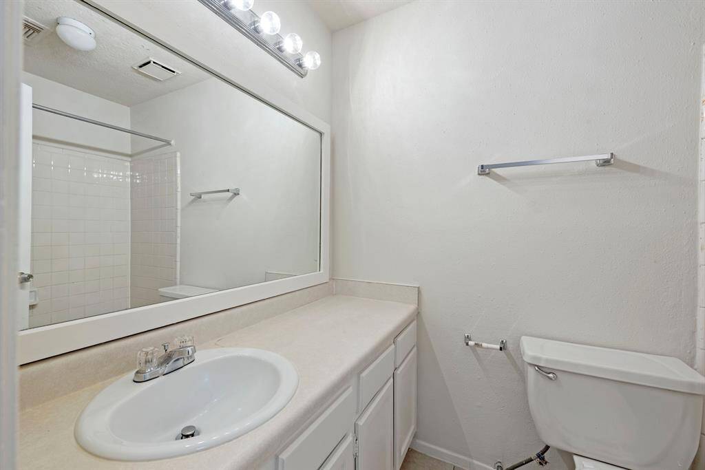 Hall bath serves the secondary bedrooms.
