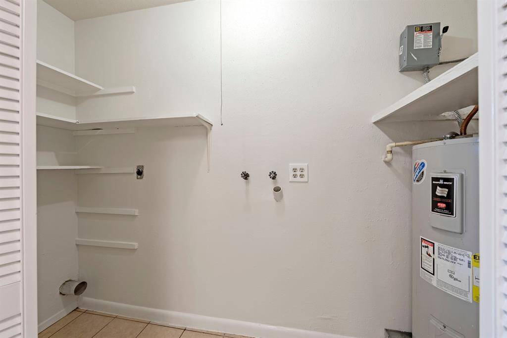 Utility holds water heater and has shelving for all of your cleaning supplies.