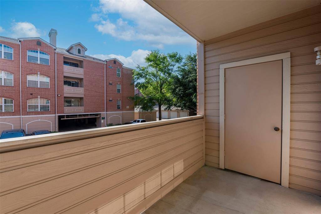 View from your spacious covered balcony with beige paneling and an adequate storage space door - perfect for a moment of relaxation after a long day.