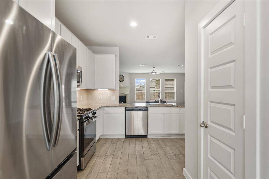 Host your next dinner party with confidence! This masterfully-equipped kitchen features walk-in pantry, an abundance of cabinetry, TONS of counter space, granite countertops, tile floors, and stainless-steel appliances.